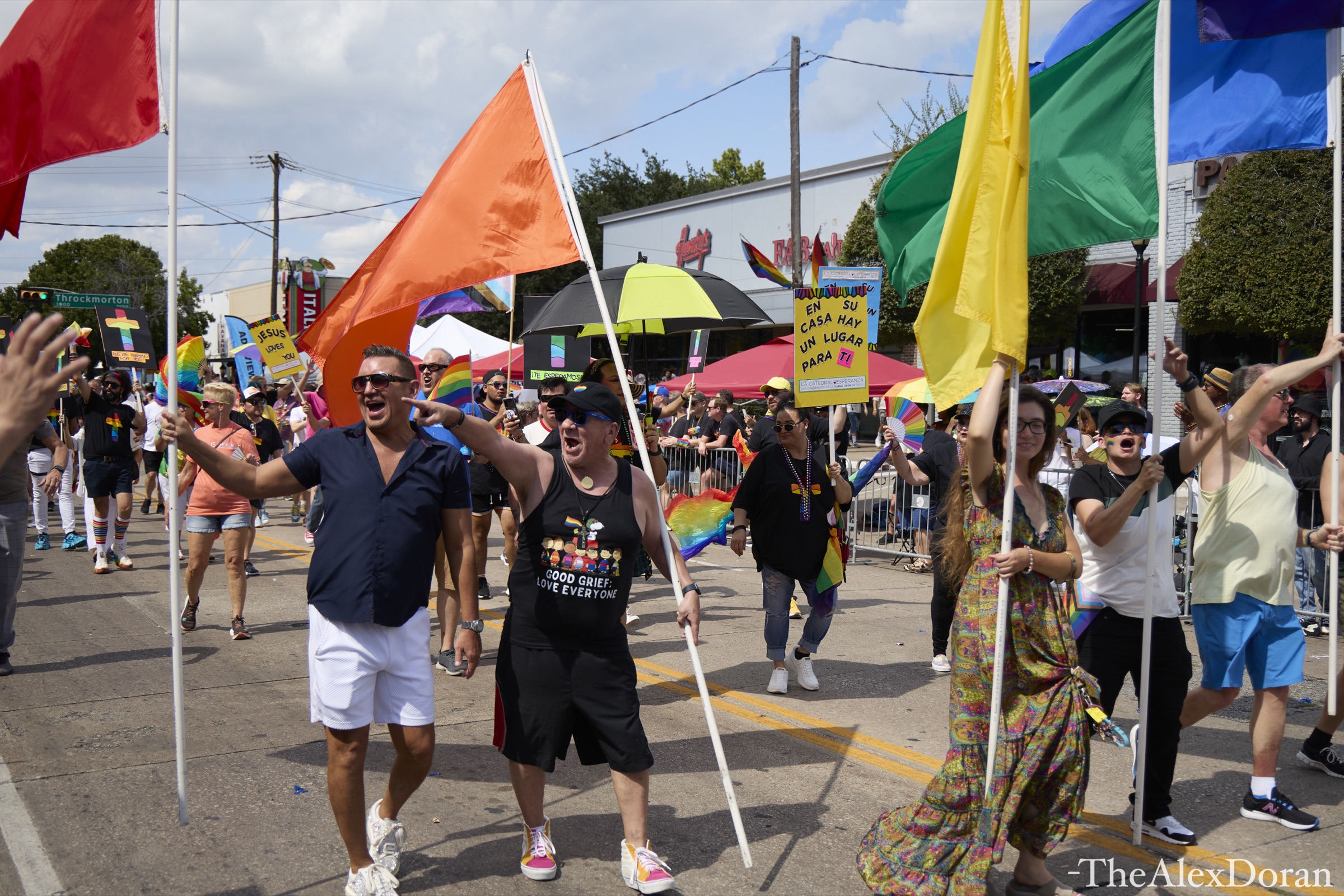 Pride in Dallas parade on Cedar Springs Boulevard with rainbow flags